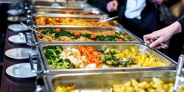 Catering trays of pasta and vegetables ready for an event