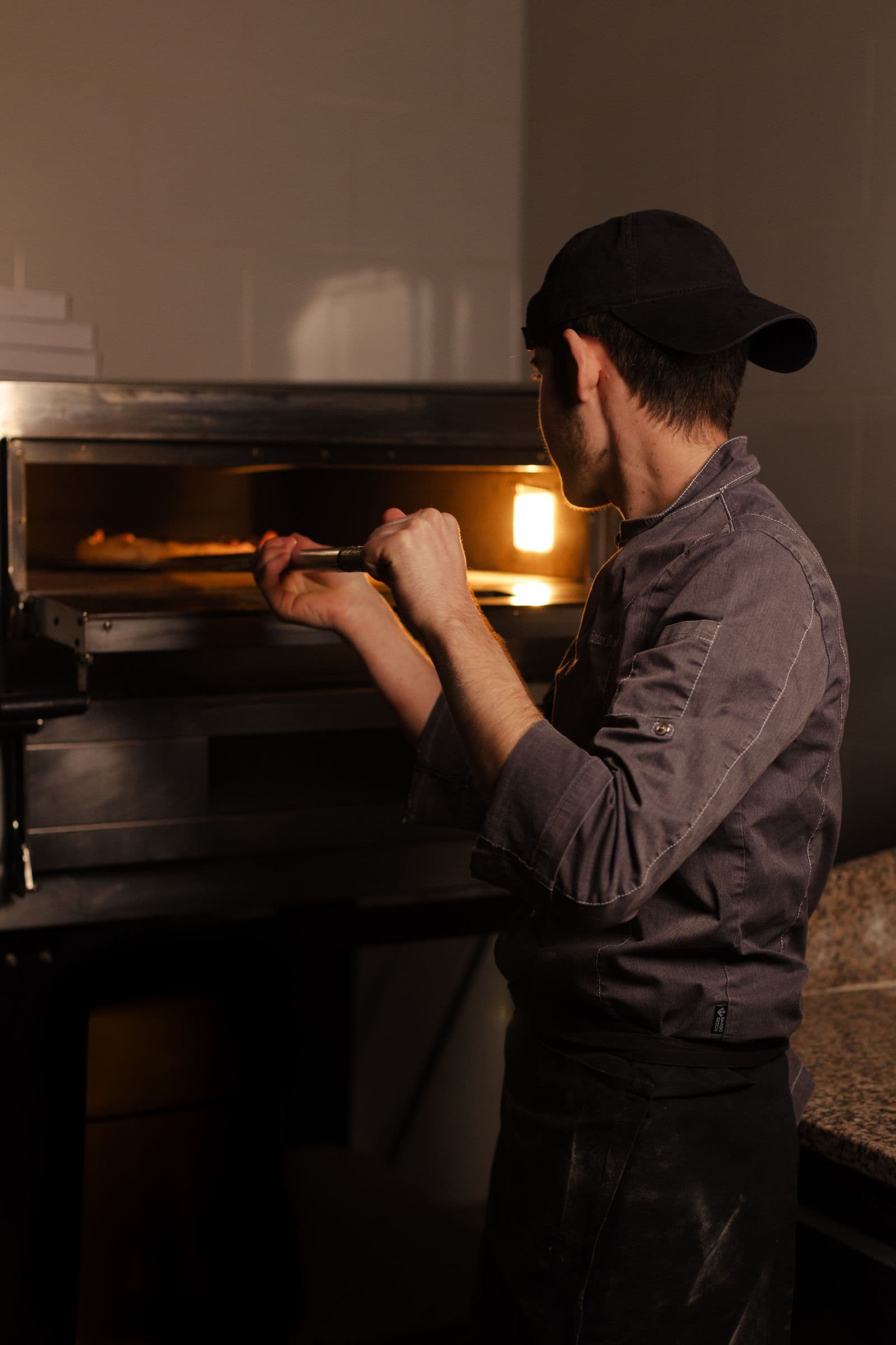 A pizza going into a glowing pizza oven
